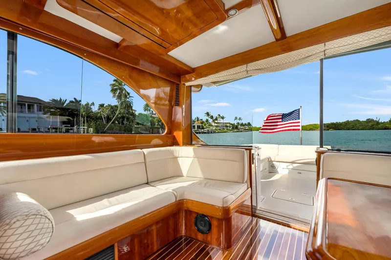 Slide: The Image of Luxurious 2015 Hinckley Talaria 43 Motoryacht interior with elegant wood finish and waterfront view. - 5