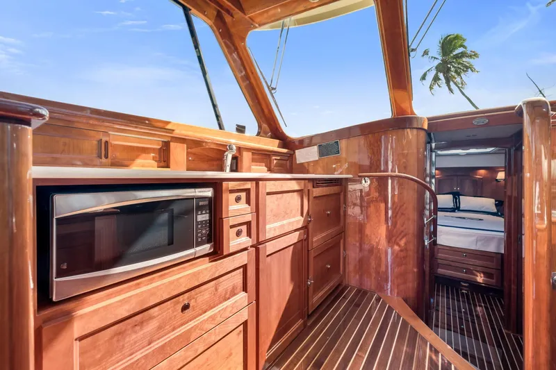 Slide: The Image of Luxurious interior of 2015 Hinckley Talaria 43 Motoryacht with wood finish and modern amenities. - 6