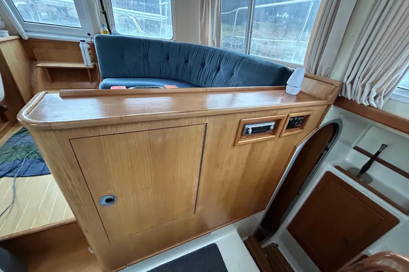 Slide: The Image of Interior of 2004 PDQ 34 Power Catamaran with wood paneling and seating area. - 14
