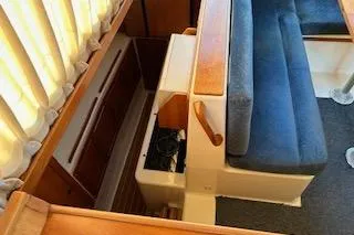 Slide: The Image of 2004 PDQ 34 Power Catamaran interior with blue seating and wooden accents. - 15