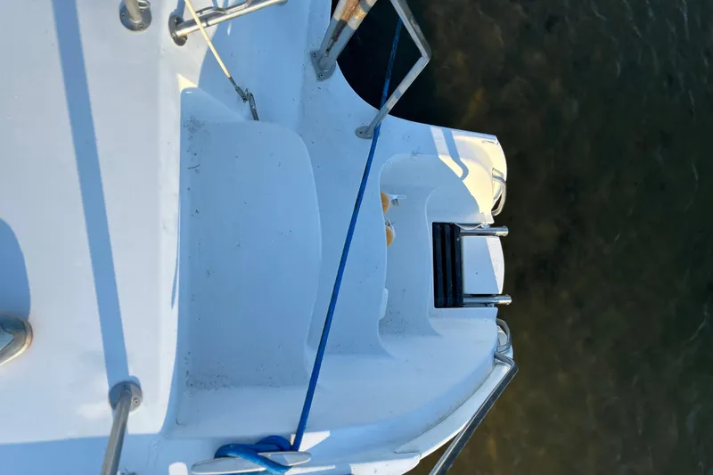 Slide: The Image of 2004 PDQ 34 Power Catamaran deck with blue rope and metal railings. - 23