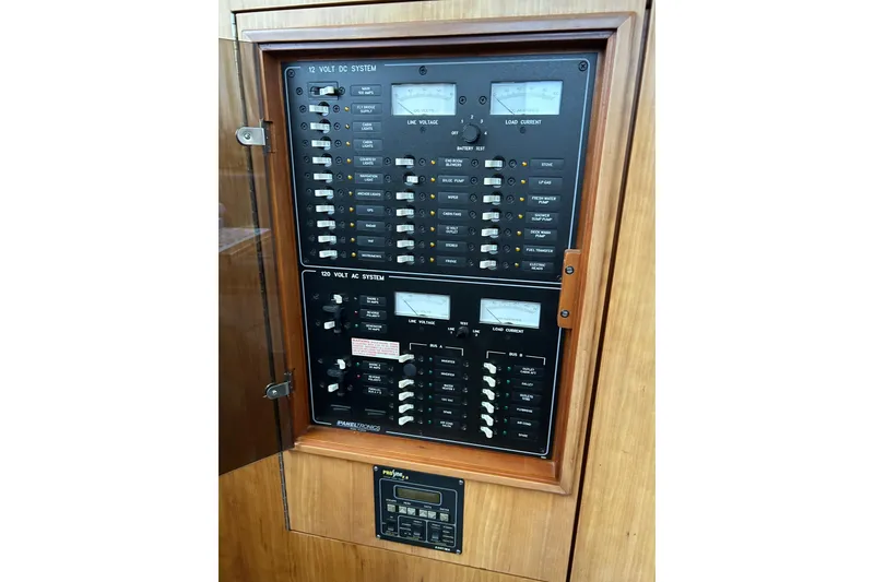 Slide: The Image of Electrical panel of 2004 PDQ 34 Power Catamaran, featuring 12V DC and 120V AC systems. - 24