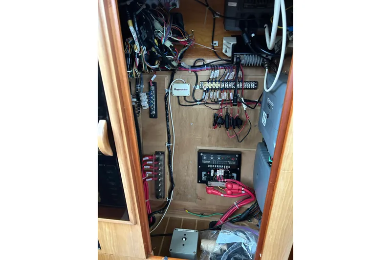 Slide: The Image of Electrical panel inside 2004 PDQ 34 Power Catamaran, showcasing wiring and components. - 25