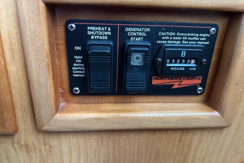 Slide: The Image of Control panel of a 2004 PDQ 34 Power Catamaran with generator settings. - 26