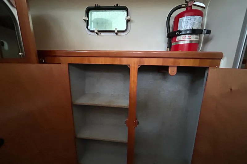 Slide: The Image of Interior of 2004 PDQ 34 Power Catamaran with wooden cabinet and fire extinguisher. - 28