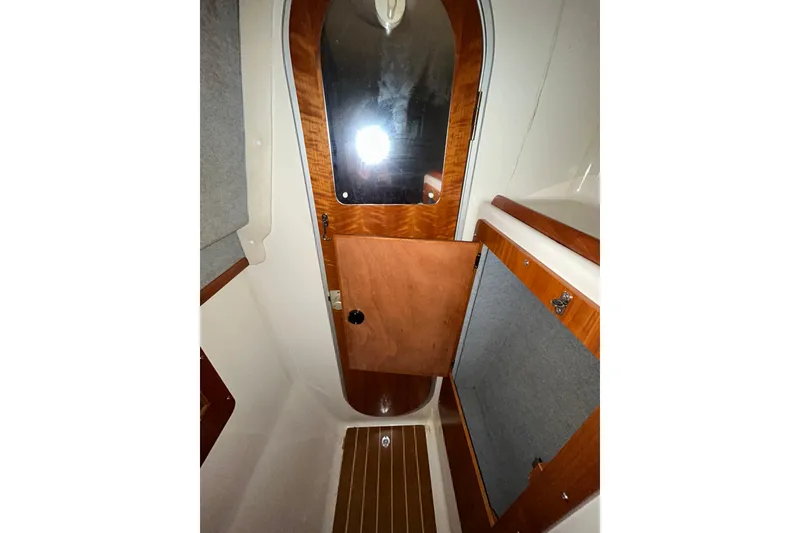 Slide: The Image of 2004 PDQ 34 Power Catamaran interior with wooden door and cabinetry. - 29