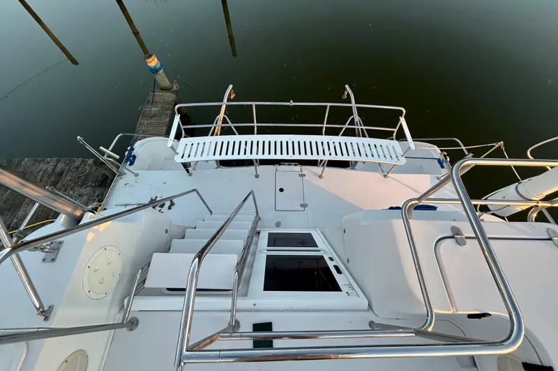 Slide: The Image of 2004 PDQ 34 Power Catamaran deck with stainless steel railings and dock view. - 3