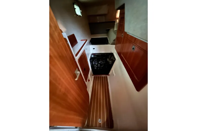 Slide: The Image of 2004 PDQ 34 Power Catamaran interior with wood cabinetry and compact kitchen area. - 30