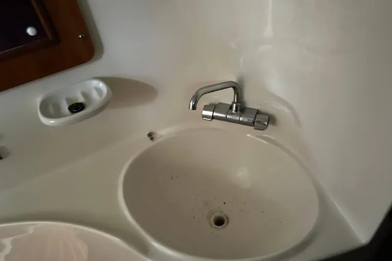 Slide: The Image of 2004 PDQ 34 Power Catamaran bathroom sink with faucet and soap holder. - 31