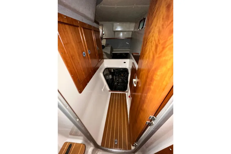 Slide: The Image of Interior view of 2004 PDQ 34 Power Catamaran with wooden cabinetry and flooring. - 33