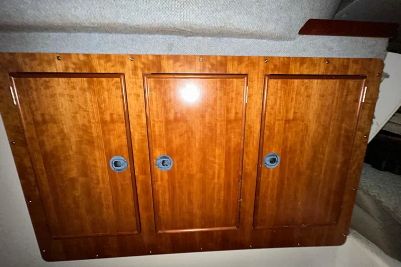 Slide: The Image of Wooden cabinet doors inside 2004 PDQ 34 Power Catamaran, showcasing sleek marine interior design. - 34