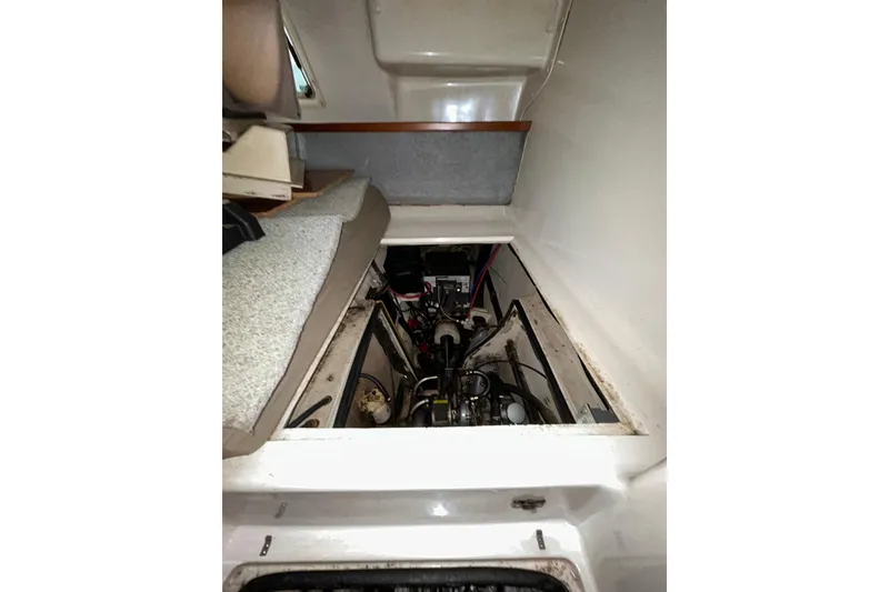 Slide: The Image of 2004 PDQ 34 Power Catamaran engine compartment with visible machinery and seating area. - 36