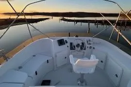 Slide: The Image of 2004 PDQ 34 Power Catamaran helm with serene sunset view over calm waters. - 4