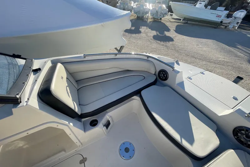 Slide: The Image of 2021 Stingray 201 DC boat interior with white seating and speakers. - 12