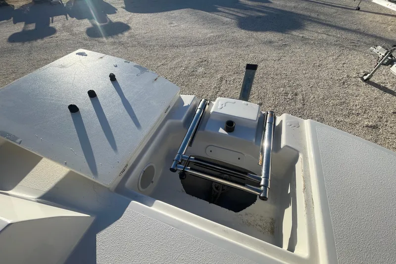 Slide: The Image of 2021 Stingray 201 DC boat deck with ladder and storage compartment. - 14