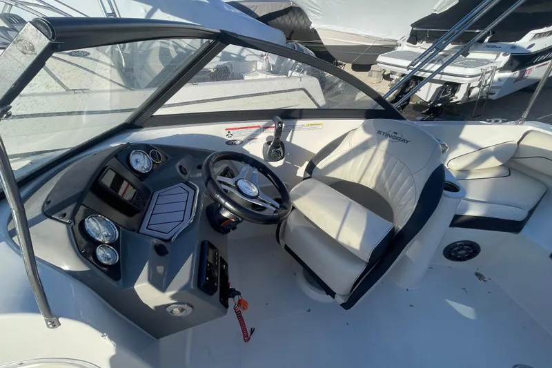 Slide: The Image of 2021 Stingray 201 DC boat interior with steering wheel and dashboard controls. - 16