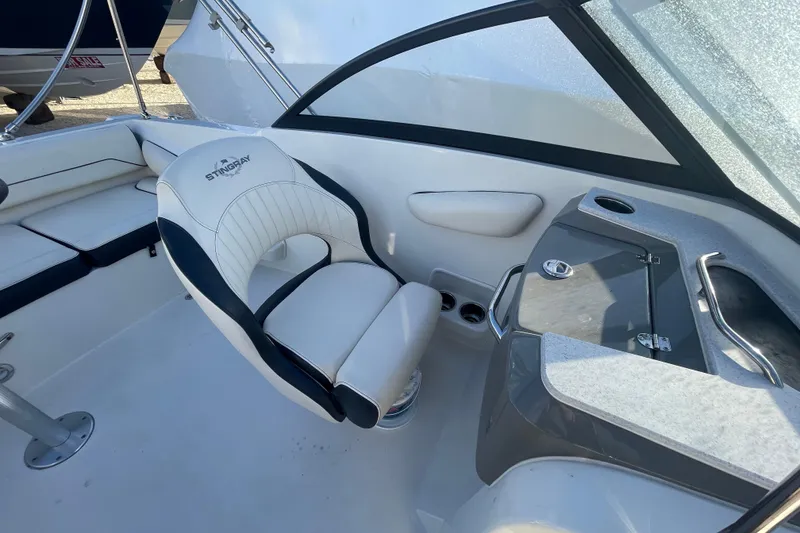 Slide: The Image of 2021 Stingray 201 DC boat interior with white seating and console. - 25