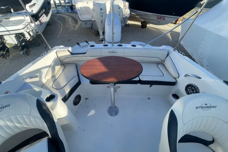 Slide: The Image of 2021 Stingray 201 DC boat interior with seating and round table. - 27
