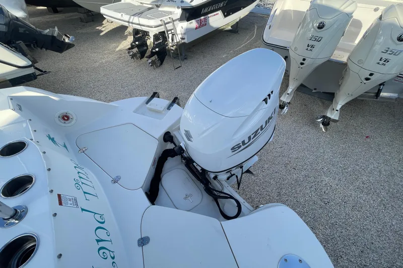Slide: The Image of 2021 Stingray 201 DC boat with Suzuki outboard motor, displayed on gravel surface. - 33