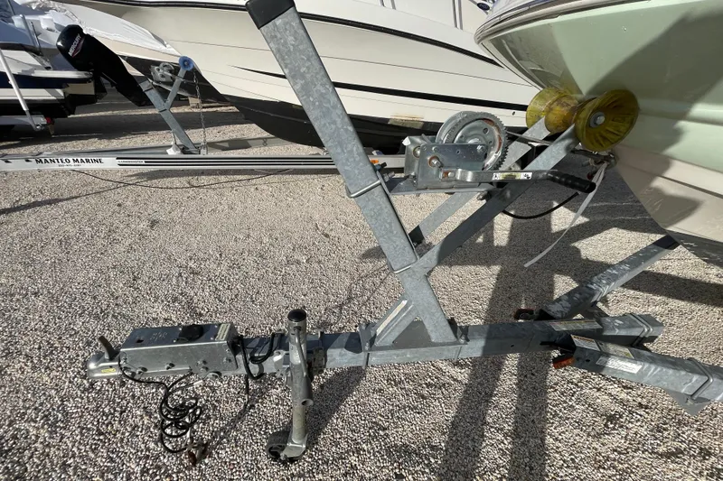 Slide: The Image of Trailer for 2021 Stingray 201 DC boat on gravel surface. - 37