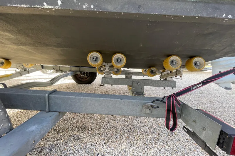 Slide: The Image of Trailer with rollers for 2021 Stingray 201 DC boat on gravel surface. - 39