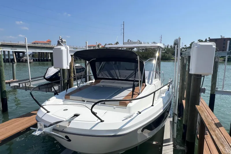 The Image of 2024 Beneteau Flyer 9 SUNdeck boat docked by a scenic waterfront. - 0