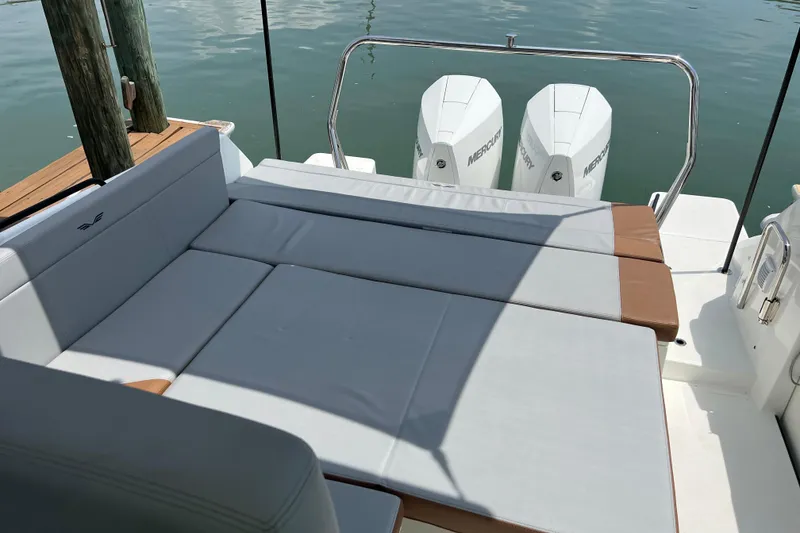 Slide: The Image of 2024 Beneteau Flyer 9 SUNdeck with cushioned seating and twin Mercury engines. - 12
