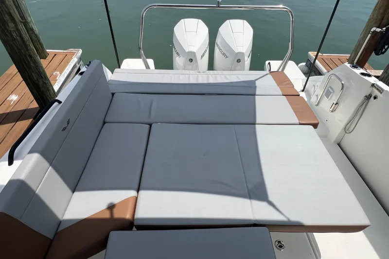 Slide: The Image of 2024 Beneteau Flyer 9 SUNdeck with cushioned seating and twin Mercury engines. - 15