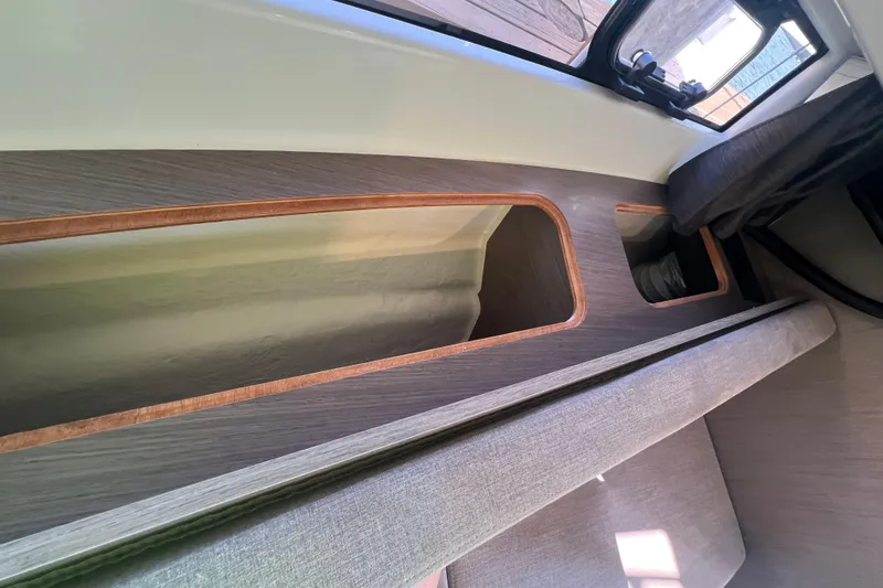 Slide: The Image of Interior view of 2024 Beneteau Flyer 9 SUNdeck, showcasing sleek wood and fabric design. - 18
