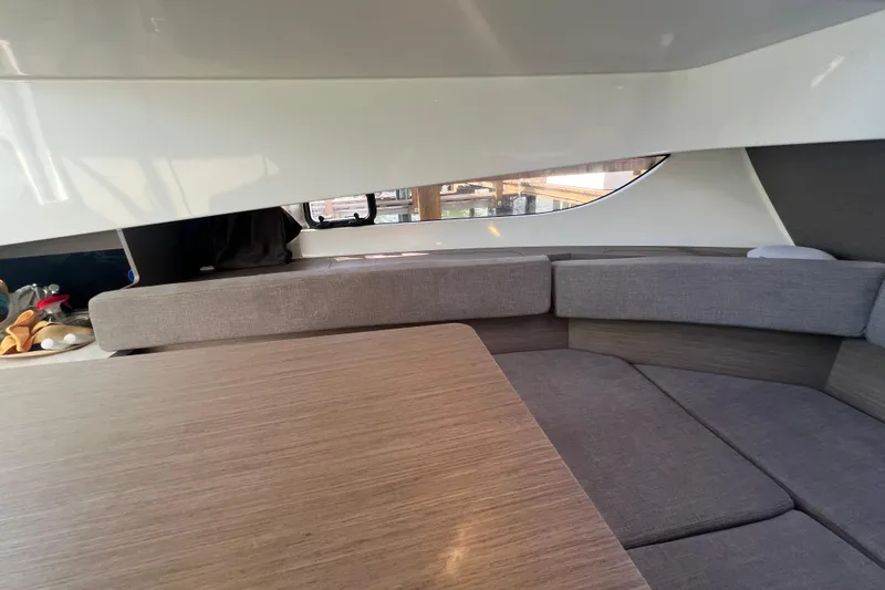 Slide: The Image of Interior of 2024 Beneteau Flyer 9 SUNdeck with modern seating and wooden table. - 19