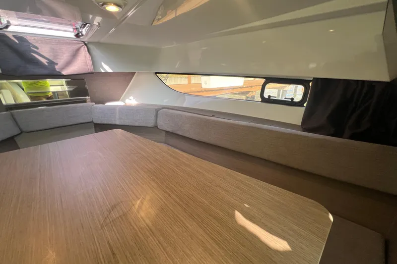 Slide: The Image of 2024 Beneteau Flyer 9 SUNdeck interior with cozy seating and wooden table. - 22