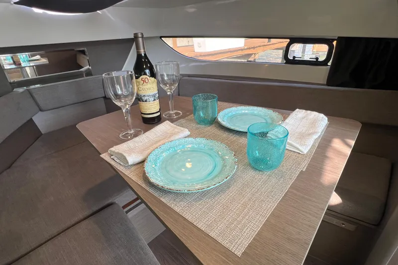 Slide: The Image of 2024 Beneteau Flyer 9 SUNdeck interior dining setup with elegant tableware and wine. - 28