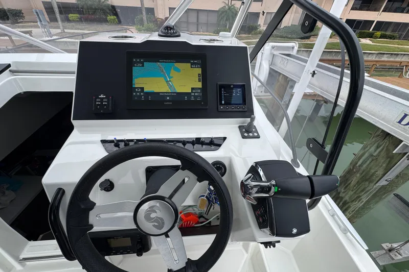 Slide: The Image of 2024 Beneteau Flyer 9 SUNdeck helm with navigation display and controls. - 3