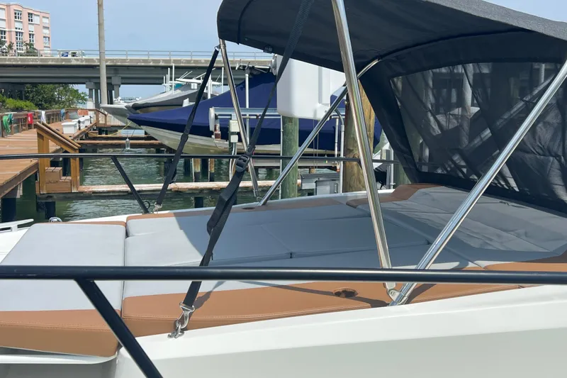 Slide: The Image of 2024 Beneteau Flyer 9 SUNdeck boat docked with sunshade and cushioned seating. - 38