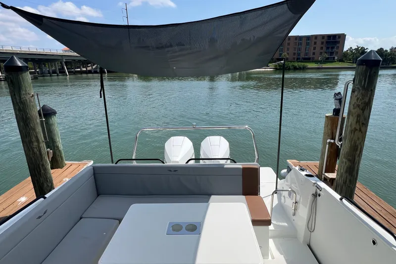 Slide: The Image of 2024 Beneteau Flyer 9 SUNdeck at dock, featuring spacious seating and dual engines. - 9