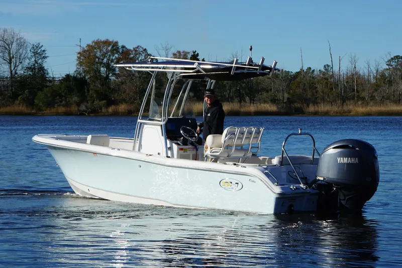 The Image of 2024 Sea Hunt Ultra 219 boat with Yamaha engine on a calm lake. - 0