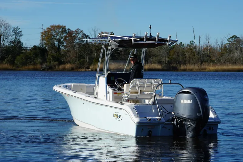 Slide: The Image of 2024 Sea Hunt Ultra 219 boat with Yamaha engine on a calm lake. - 18