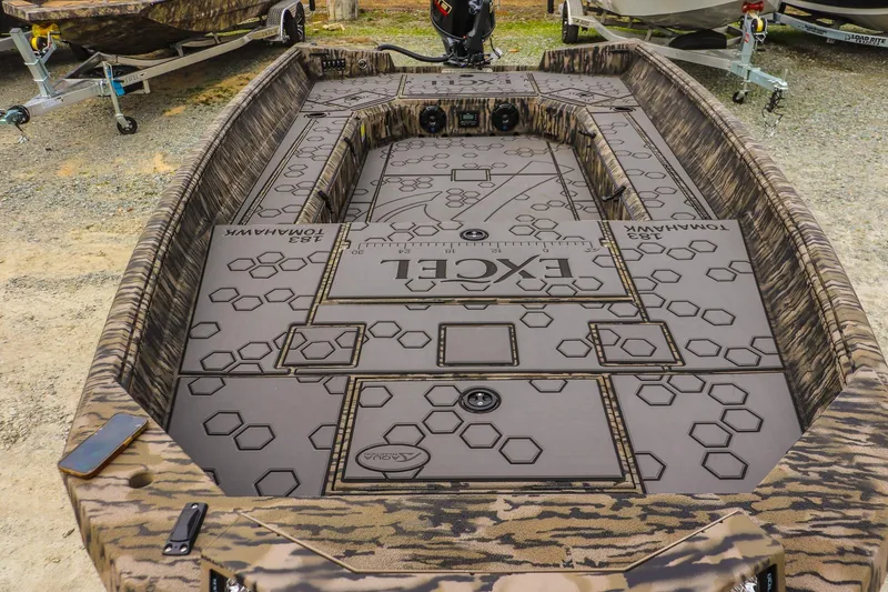 Slide: The Image of 2026 Excel Tomahawk boat interior with hexagonal pattern and camouflage design. - 12