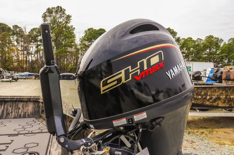 Slide: The Image of 2026 Excel Tomahawk boat with Yamaha SHO VMAX outboard motor in a wooded area. - 14