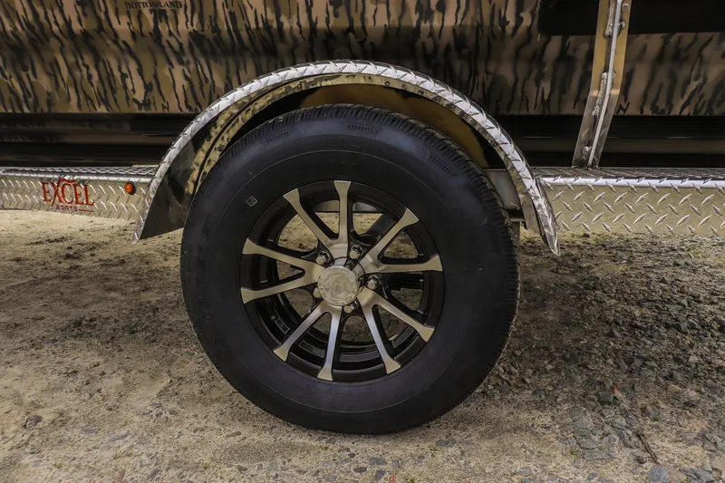 Slide: The Image of 2026 Excel Tomahawk trailer wheel with black alloy rim and diamond plate fender. - 15