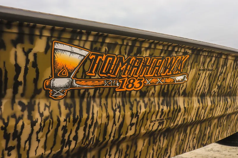 Slide: The Image of 2026 Excel Tomahawk boat with camouflage design and bold logo. - 16