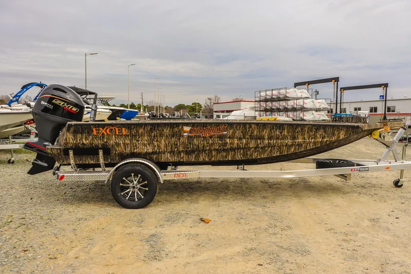 Slide: The Image of 2026 Excel Tomahawk boat with camouflage design on a trailer. - 5