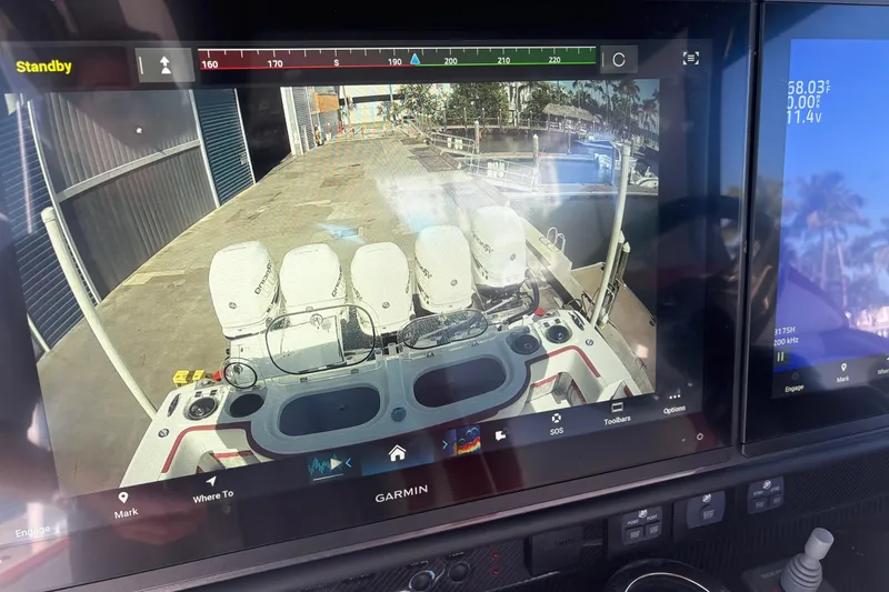 Slide: The Image of 2022 Nor-Tech 452 Super Fish dashboard with navigation and sonar displays. - 12