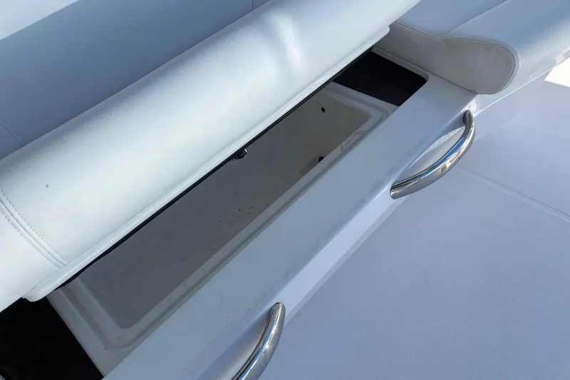 Slide: The Image of 2022 Nor-Tech 452 Super Fish boat with white and red seating, docked by the water. - 17