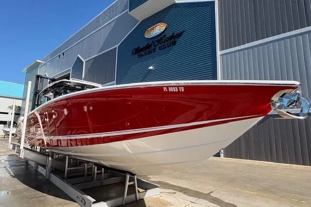 Slide: The Image of 2022 Nor-Tech 452 Super Fish boat in vibrant red, docked at a marina. - 2