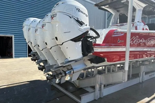 Slide: The Image of 2022 Nor-Tech 452 Super Fish boat with red hull, docked at a marina. - 4