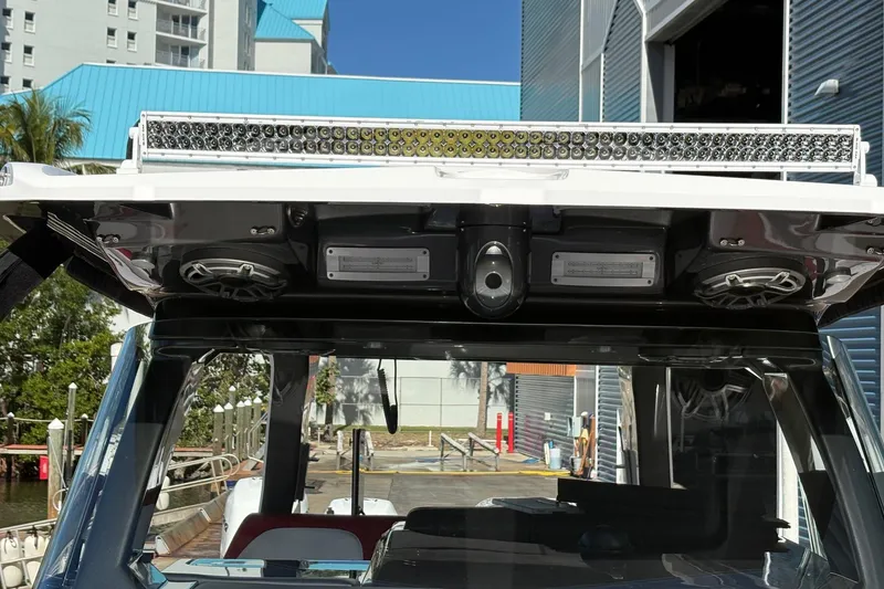 Slide: The Image of 2022 Nor-Tech 452 Super Fish boat interior with white seating and red accents. - 7