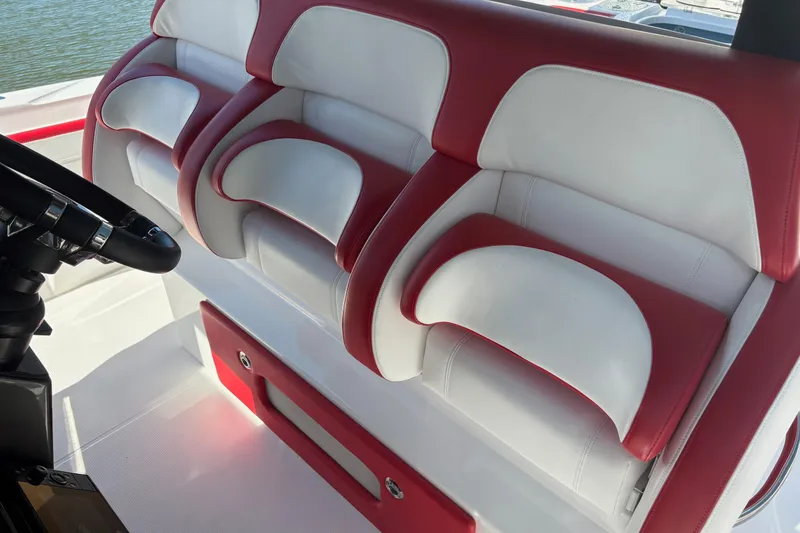 Slide: The Image of 2022 Nor-Tech 452 Super Fish boat with white and red seating, docked near a marina. - 8