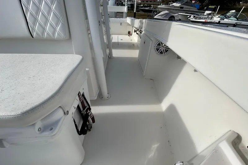 Slide: The Image of Interior view of 2022 Young Boats 27, featuring white seating and storage compartments. - 12