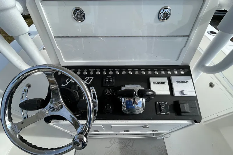 Slide: The Image of Steering console of 2022 Young Boats 27 with Suzuki and Simrad controls. - 14